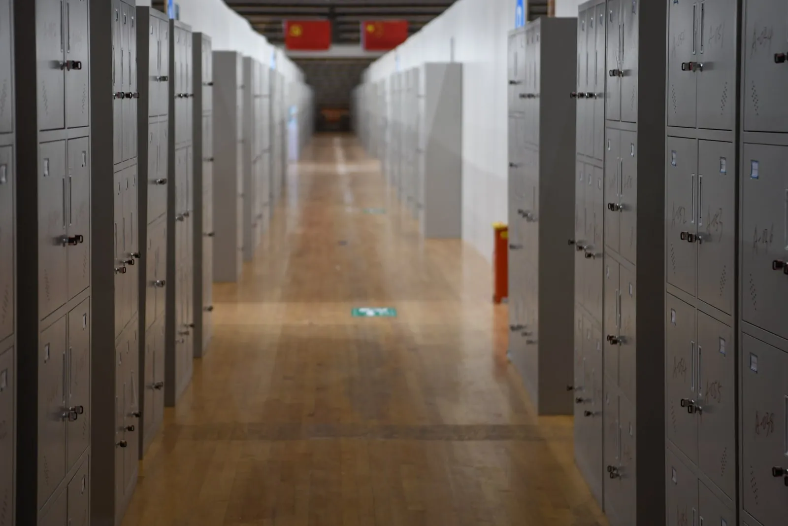 An empty school corridor lined with metal lockers