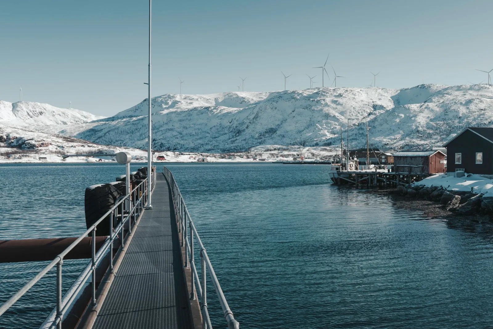 Wind turbines standing in a snow-covered northern landscape