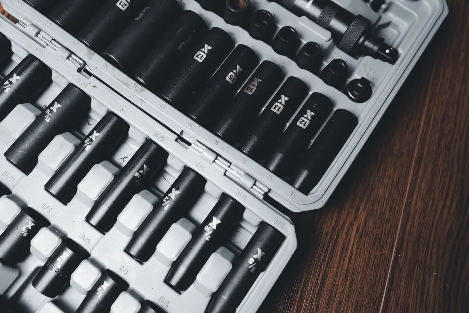 Socket wrench bits arranged in rows inside a tool case