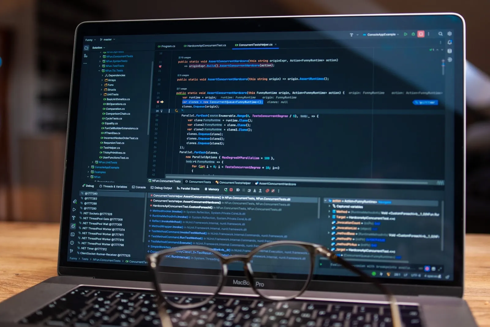 A laptop showing a code editor with a debugger panel open