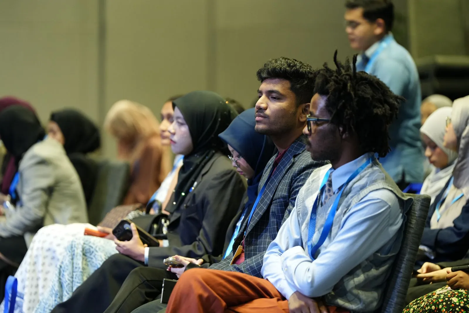 Delegates seated in rows at a large international conference