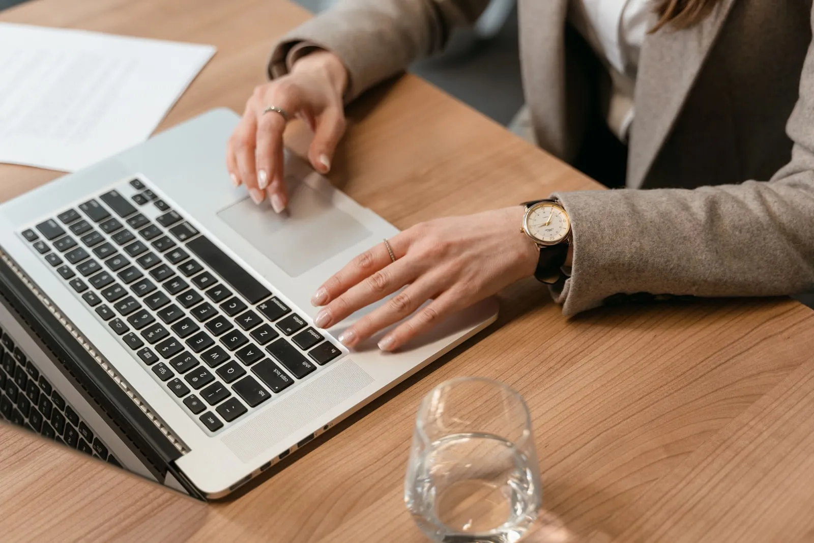 A person using a laptop at a table
