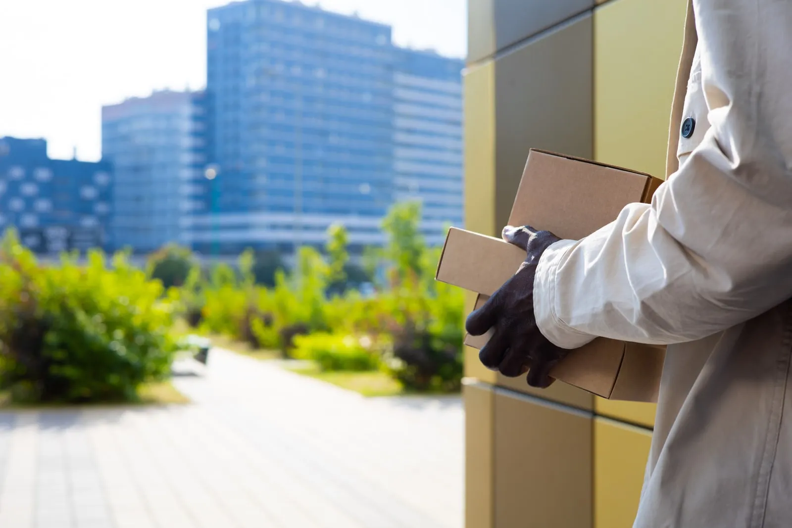 A courier carrying parcels along a city street