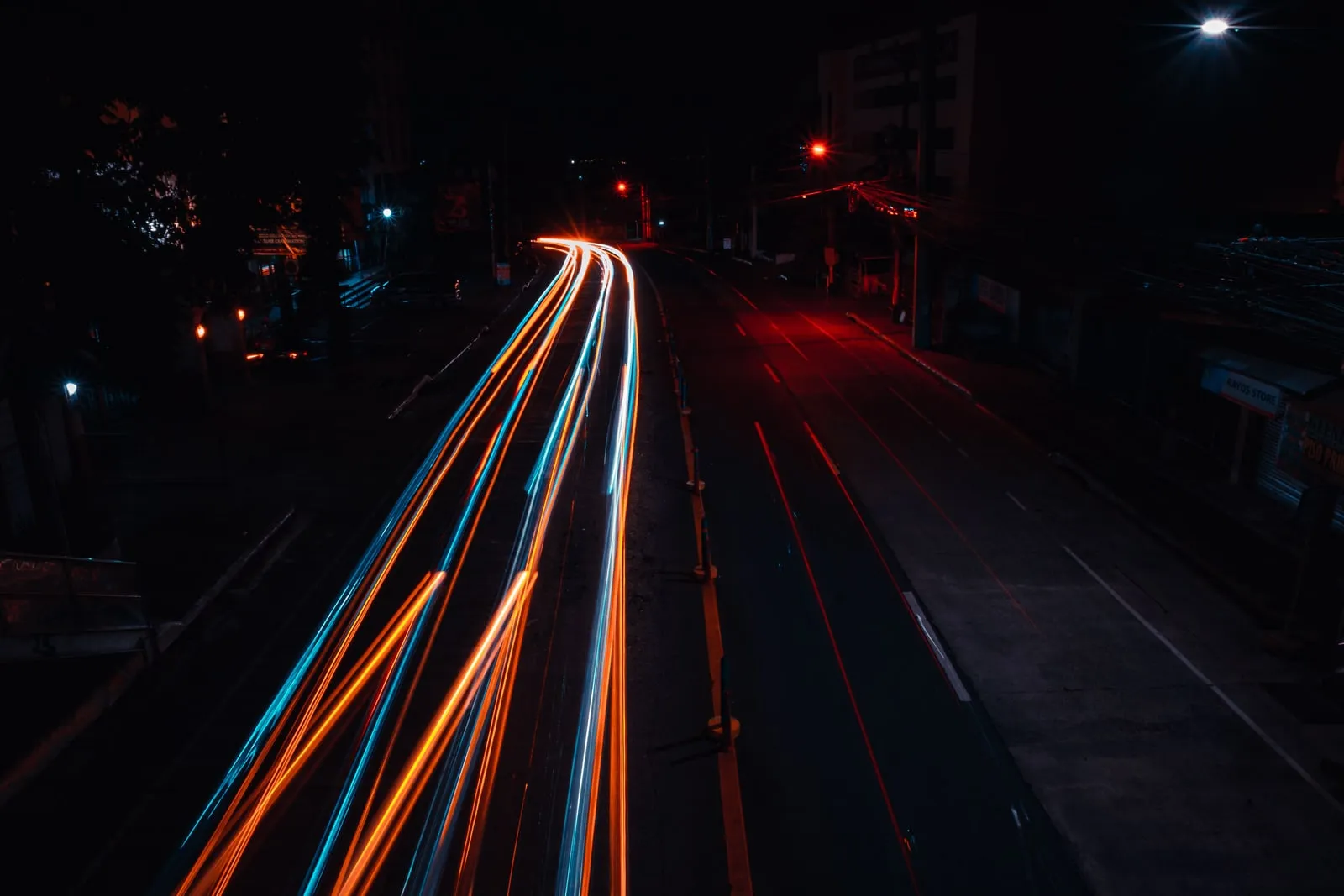 Long exposure light trails from traffic on a road at night