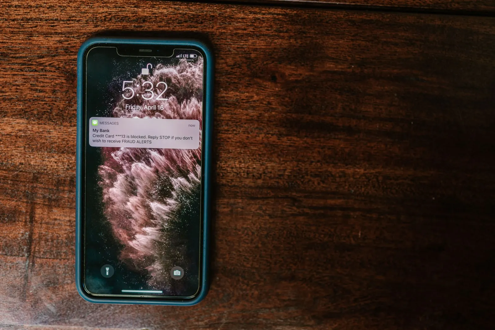 A smartphone lying on a wooden table