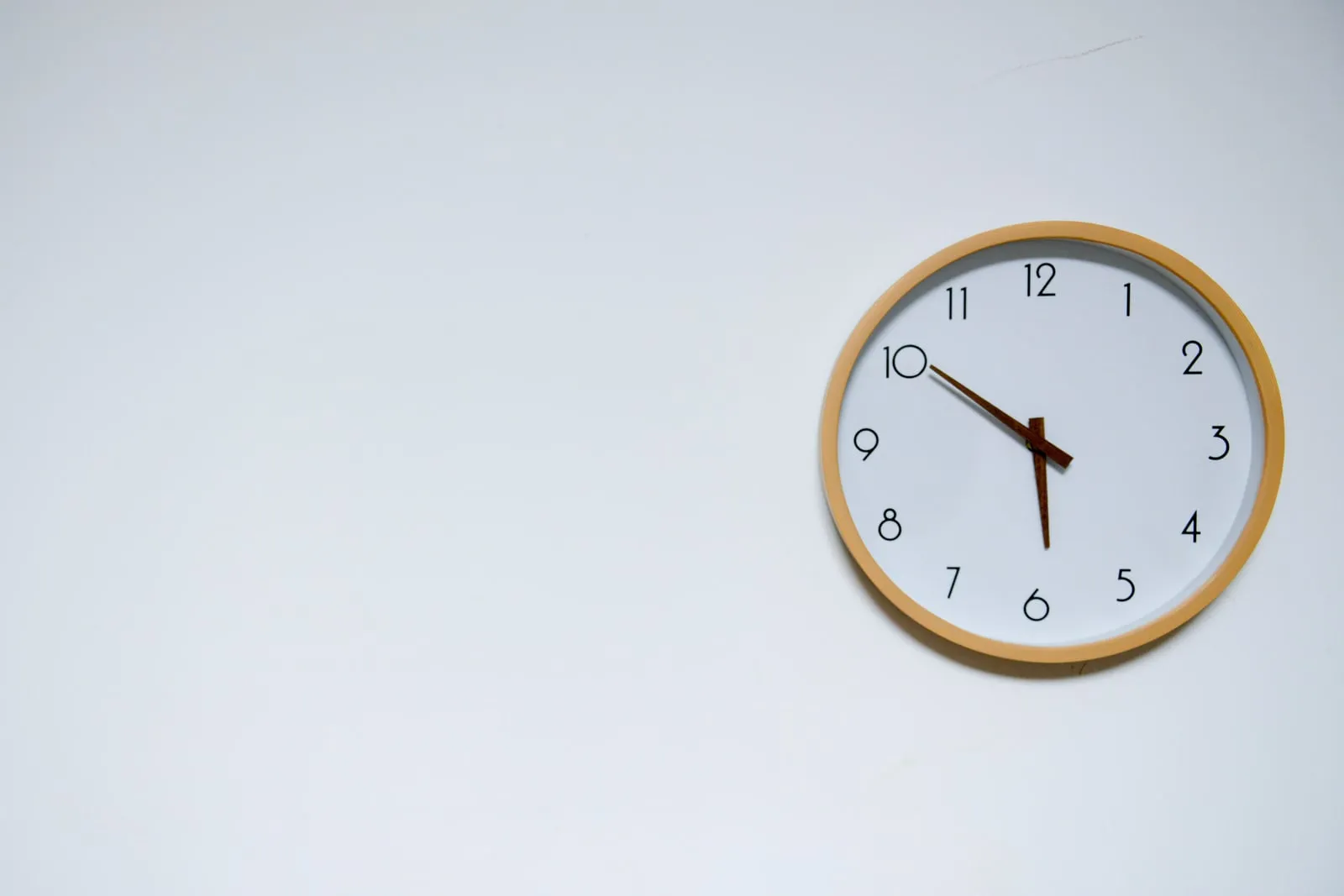 A round wall clock on an office wall
