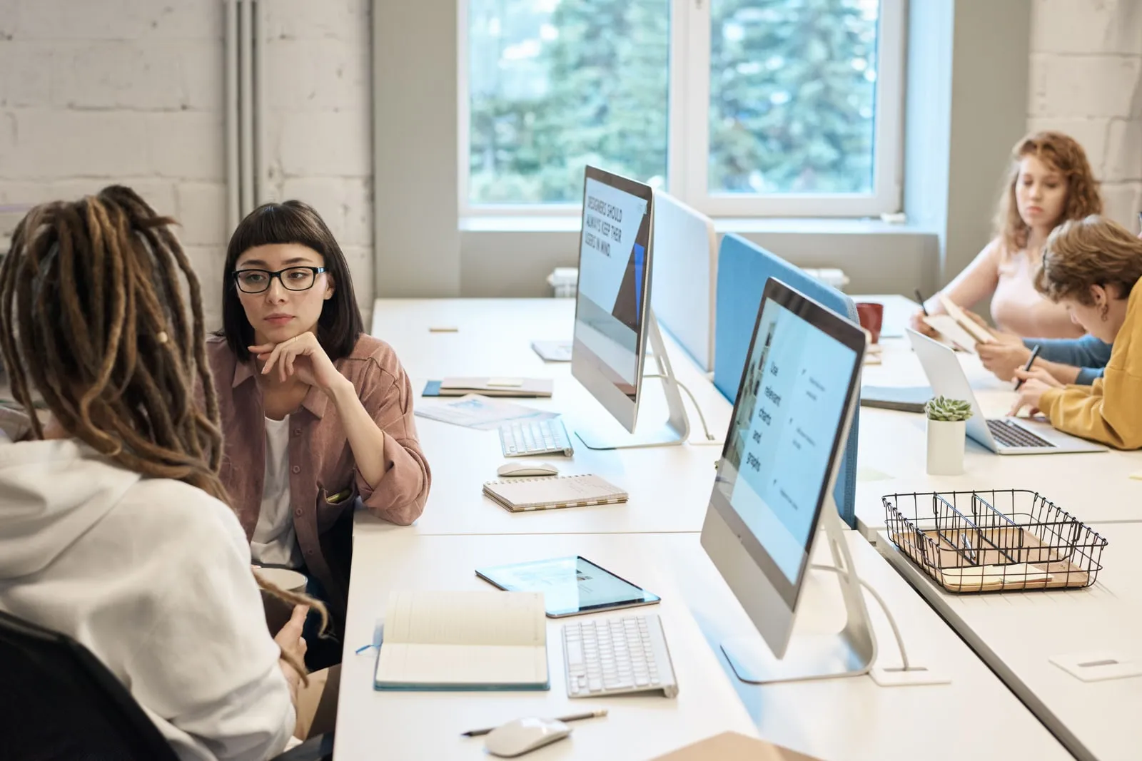 An open plan office with people working at desks