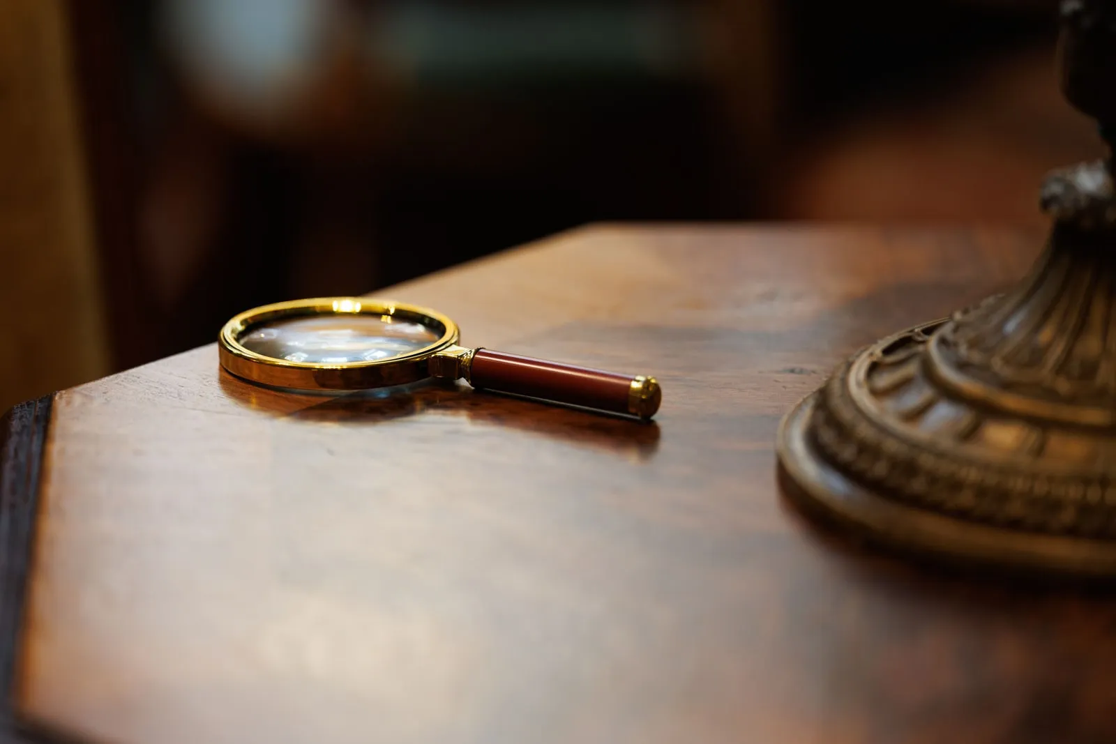 A magnifying glass lying on a wooden table