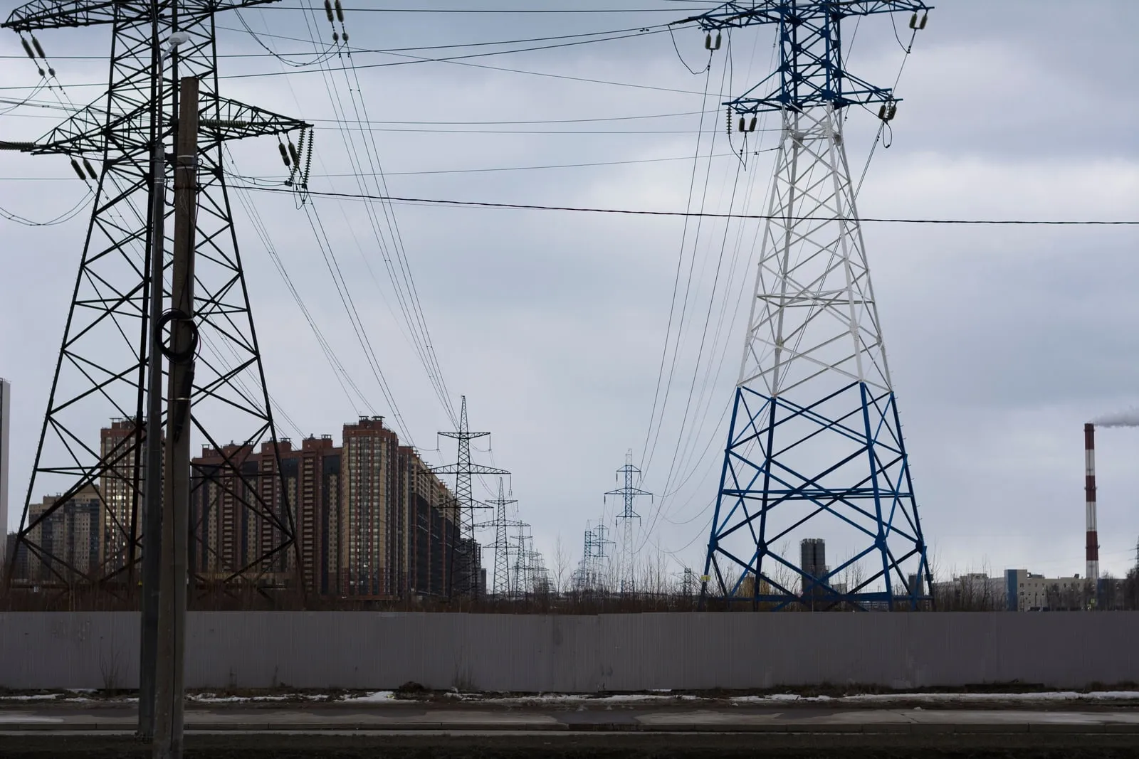 High-voltage pylons carrying power lines across an open sky