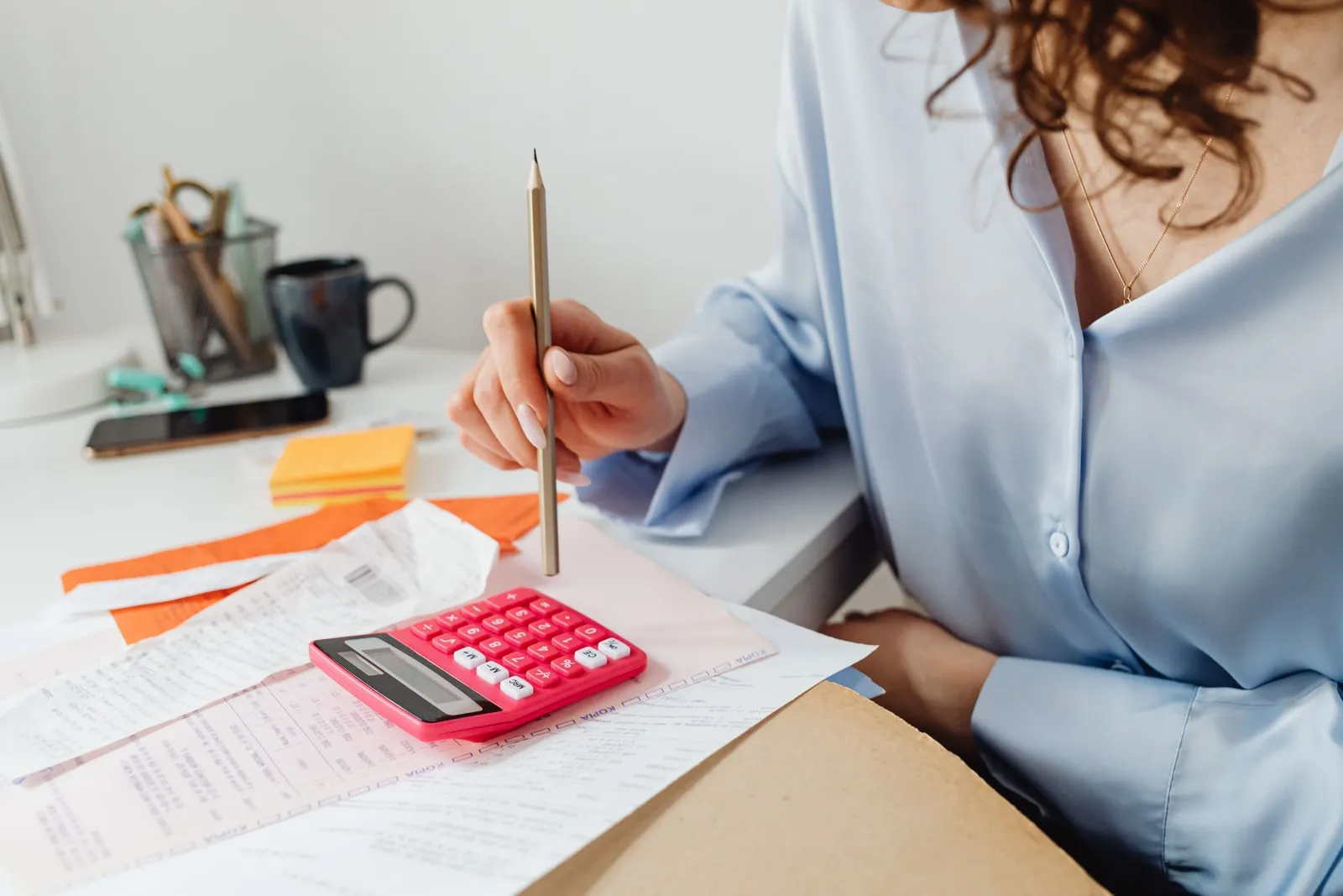 A person working through bills with a calculator