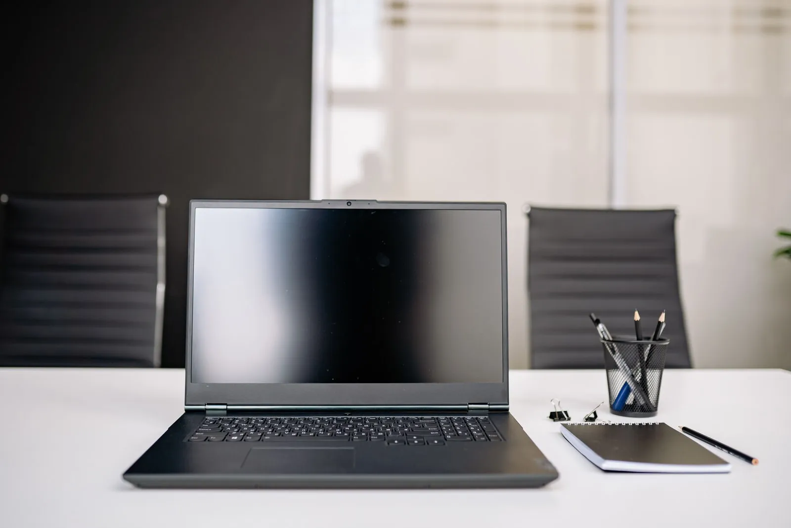 A notebook and pen on a conference table