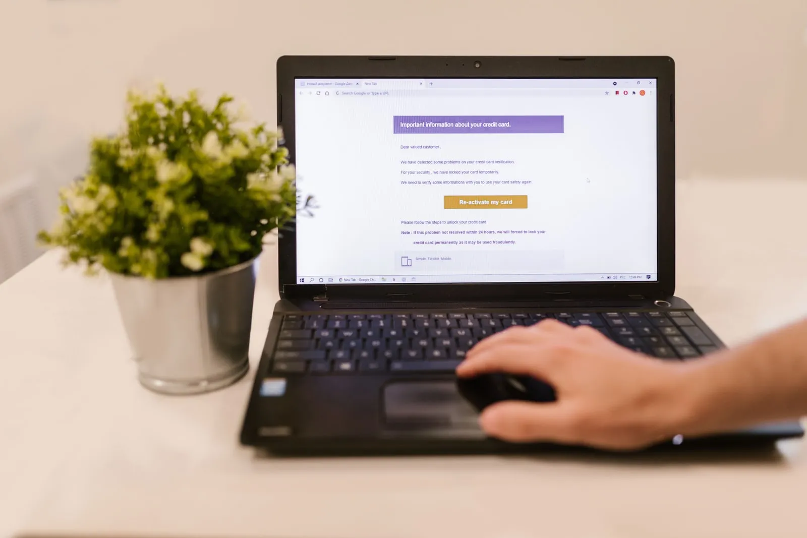 A person checking email on a laptop at a desk