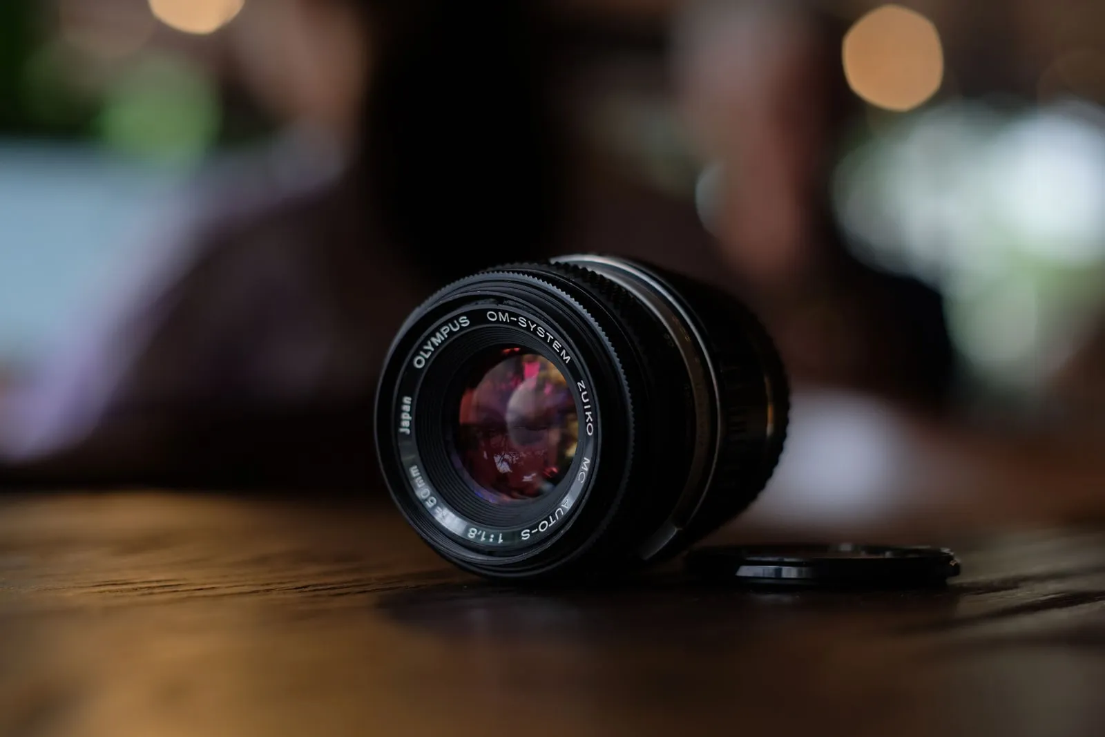 A camera lens photographed close up on a table