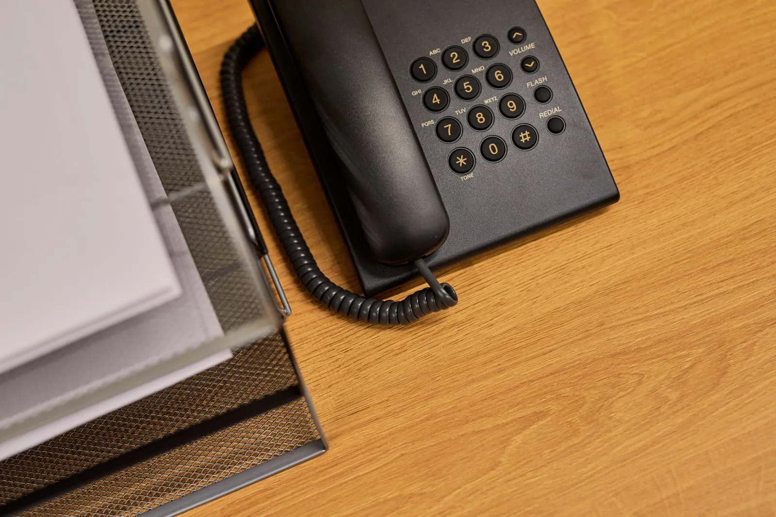 A landline telephone on a desk