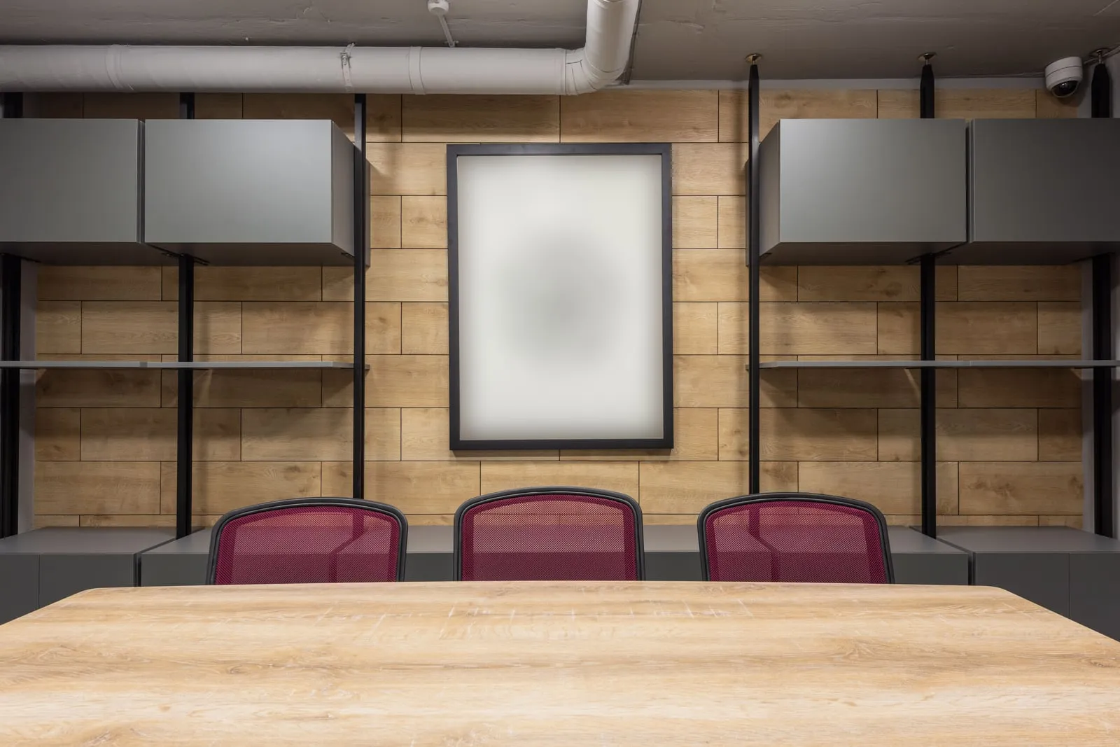 An empty conference room with a long table and chairs