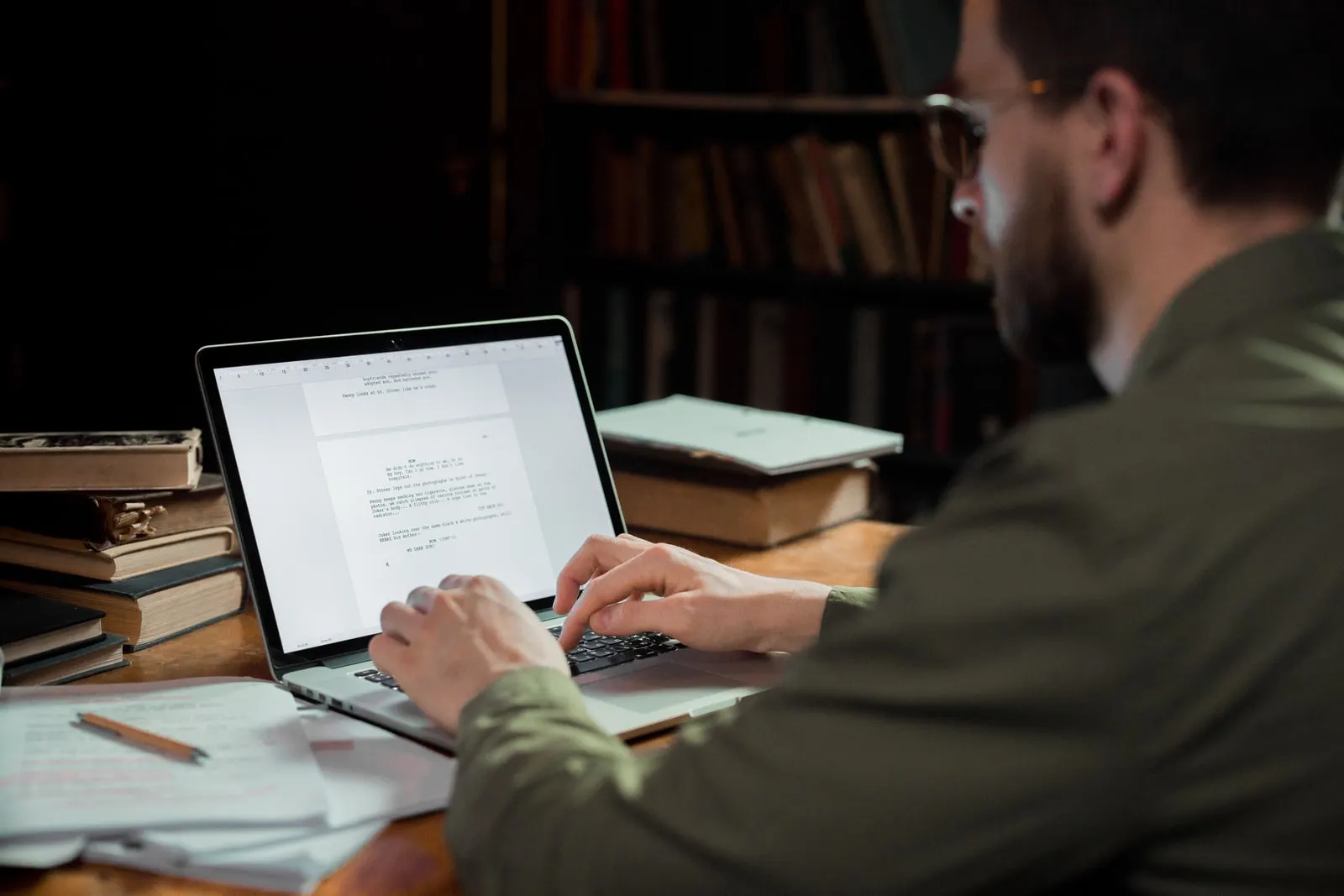 A person working at a laptop in a library