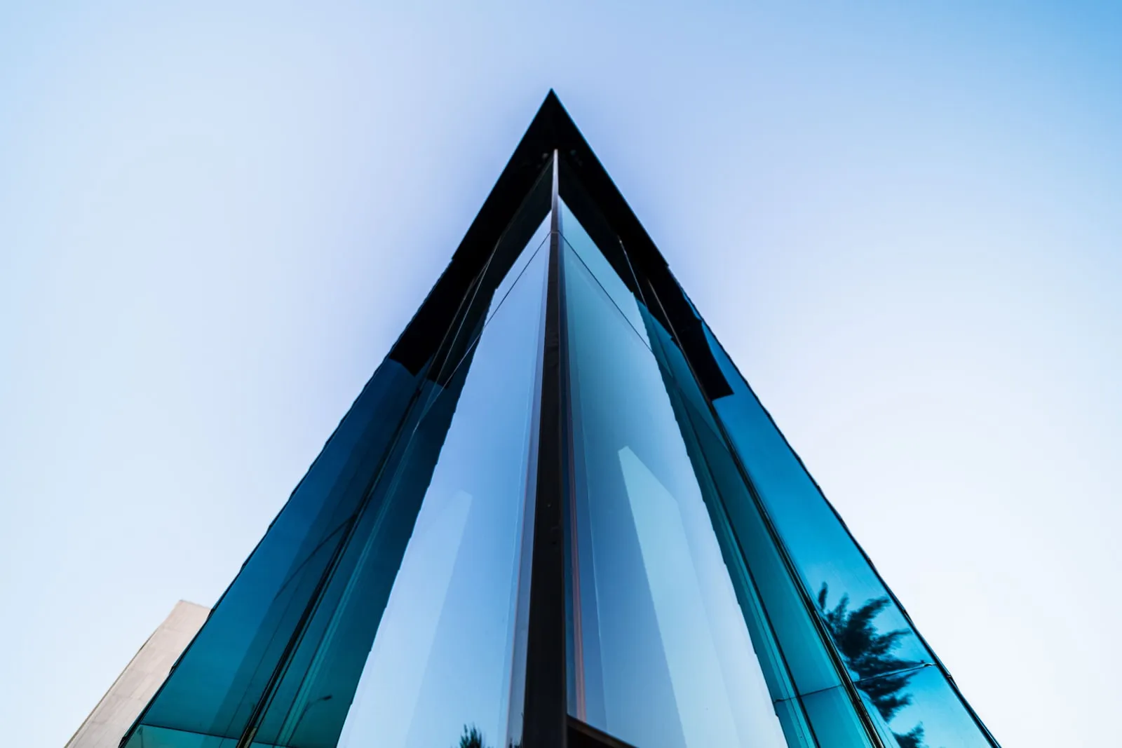 A glass skyscraper seen from below