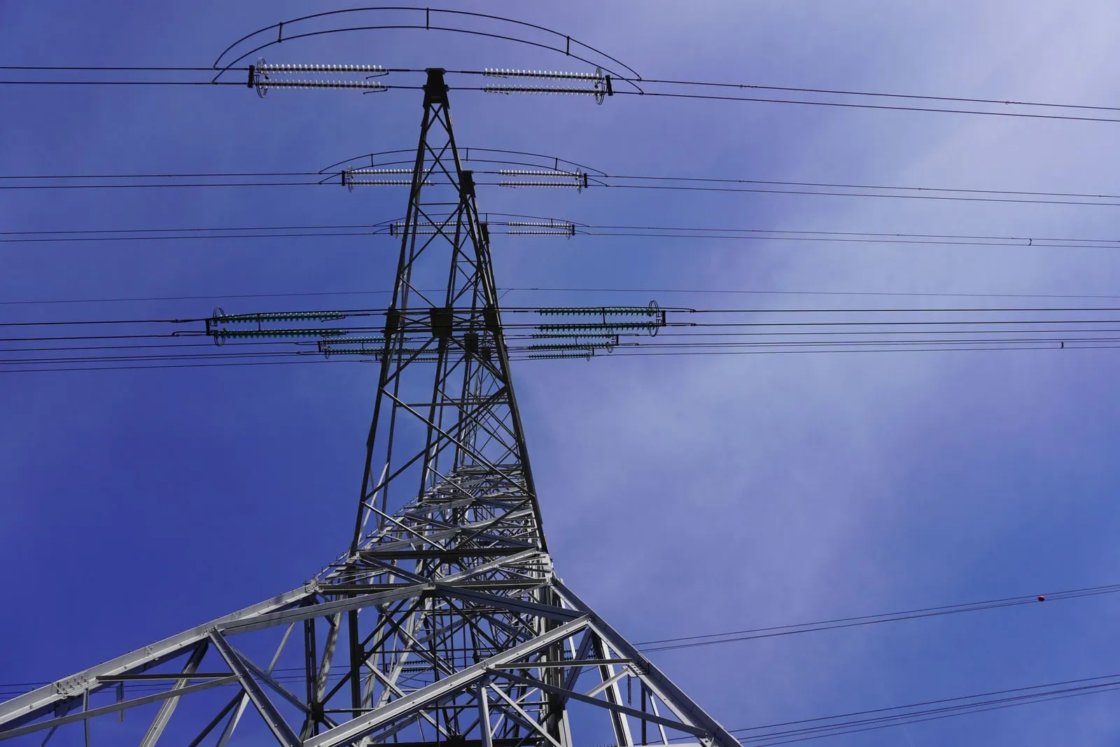 High-voltage power lines against a clear sky