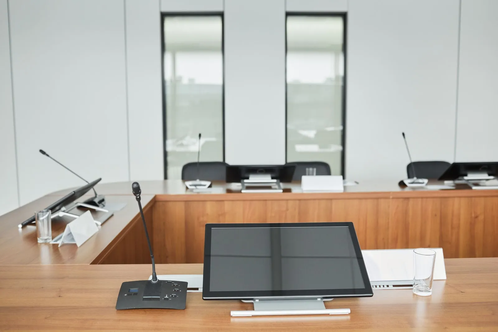 An empty boardroom with a long conference table