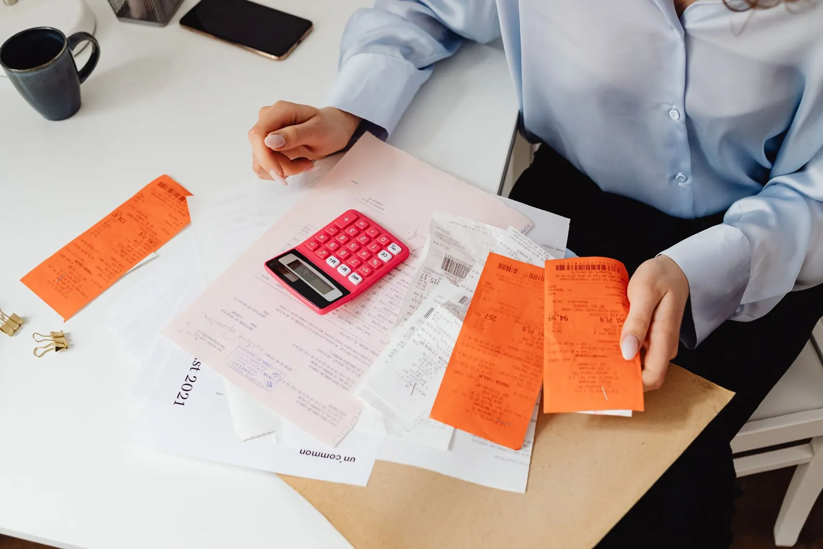 A printed medical bill and a calculator on a desk