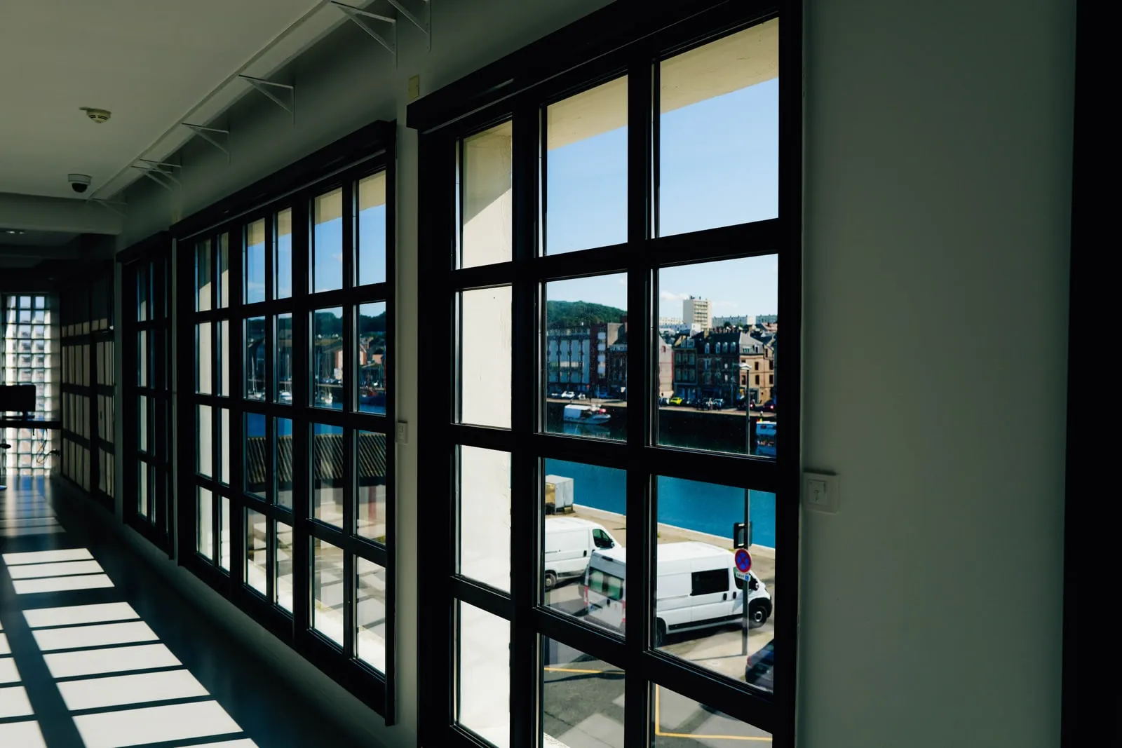 An office corridor with large windows