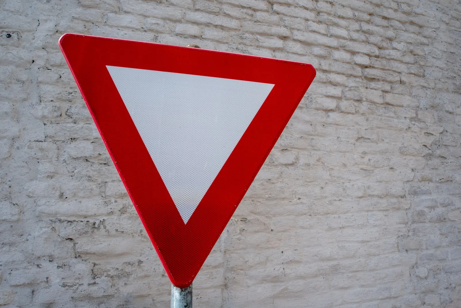 A warning triangle sign mounted on a wall