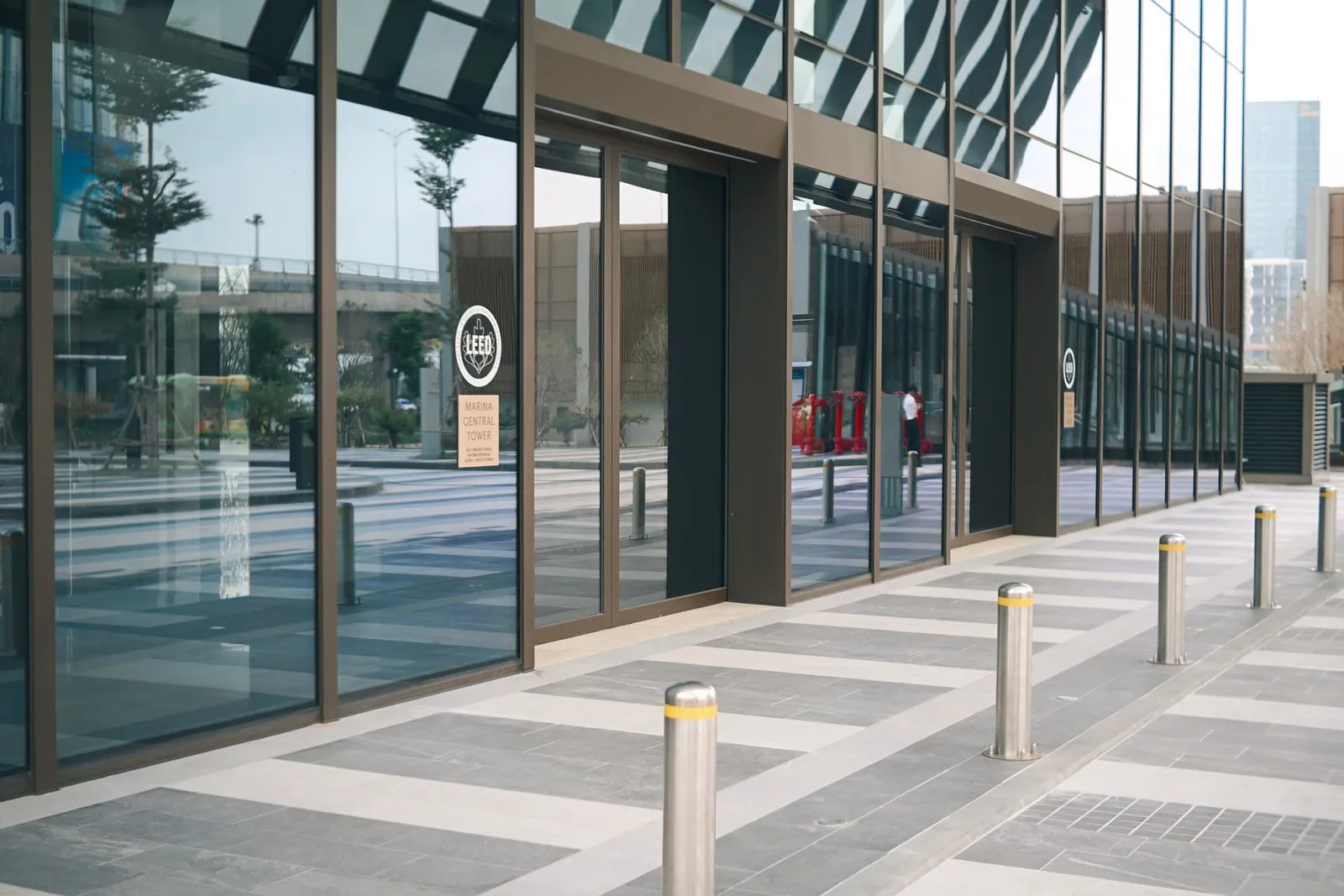 Office tower entrance with glass doors in a business district