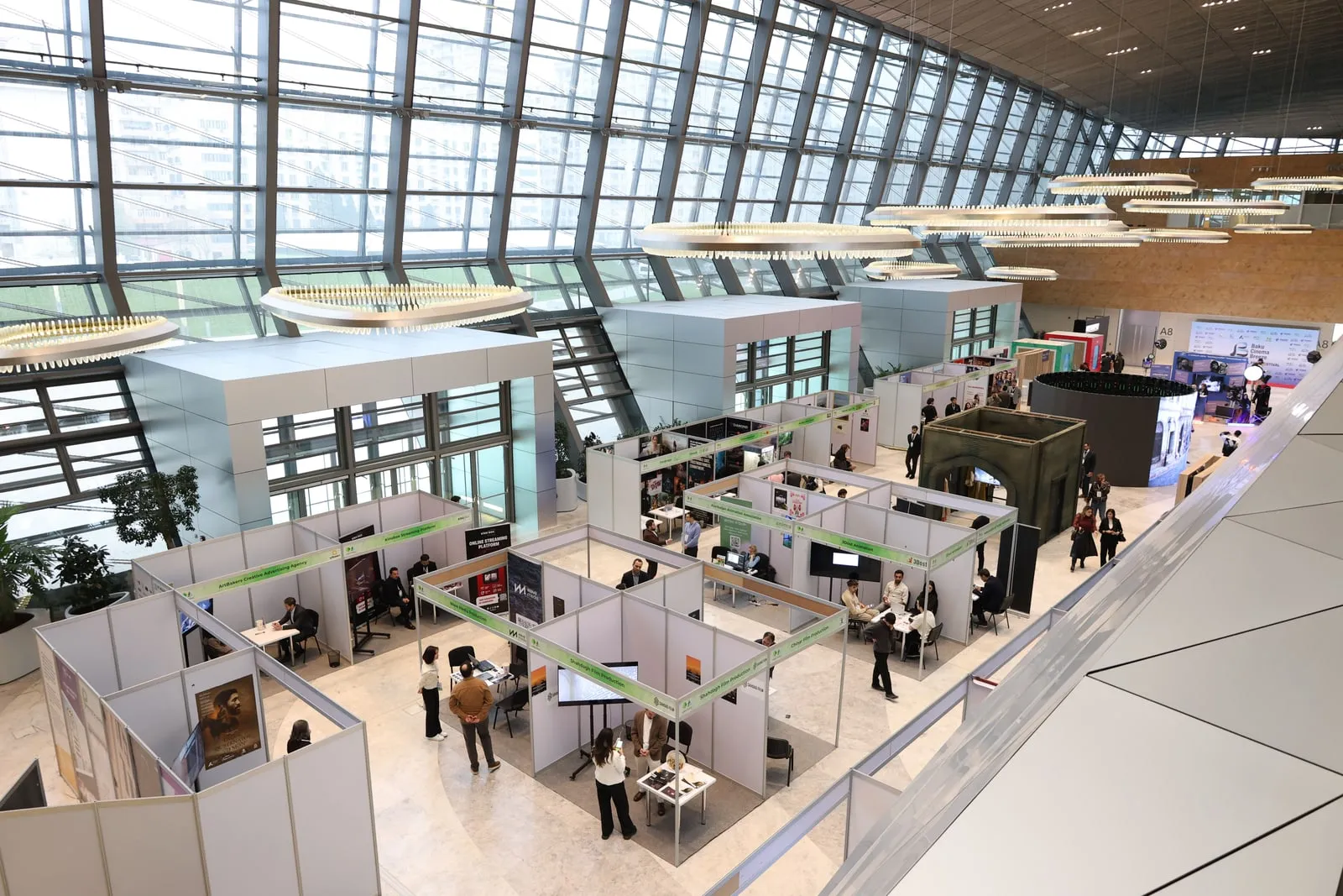 Visitors walking through a technology trade show hall