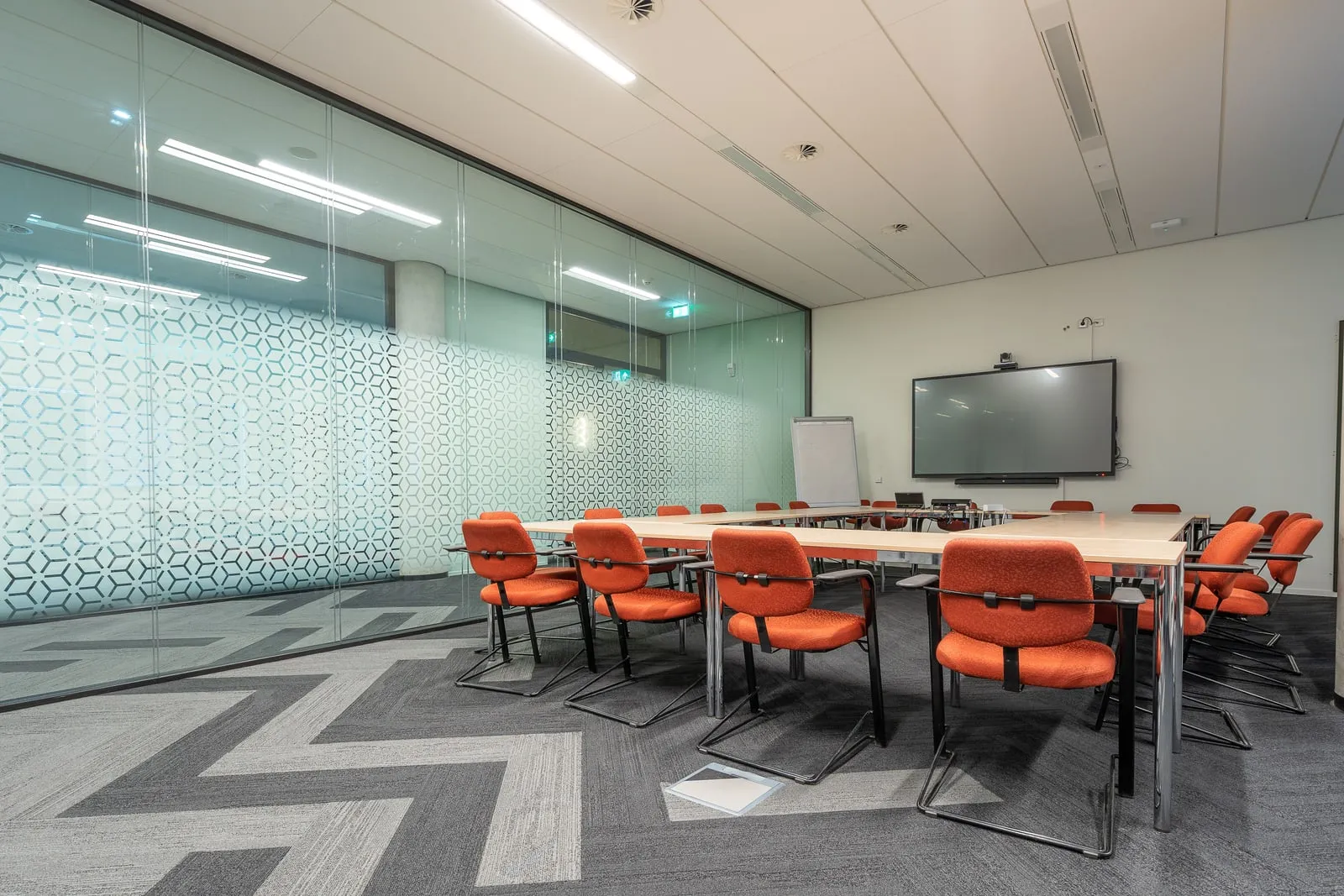 An empty meeting room behind a glass wall
