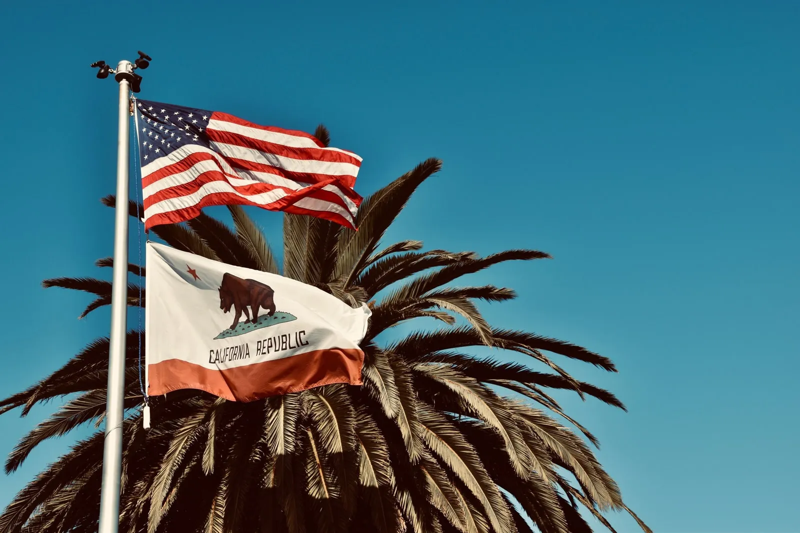 An American flag against a blue sky