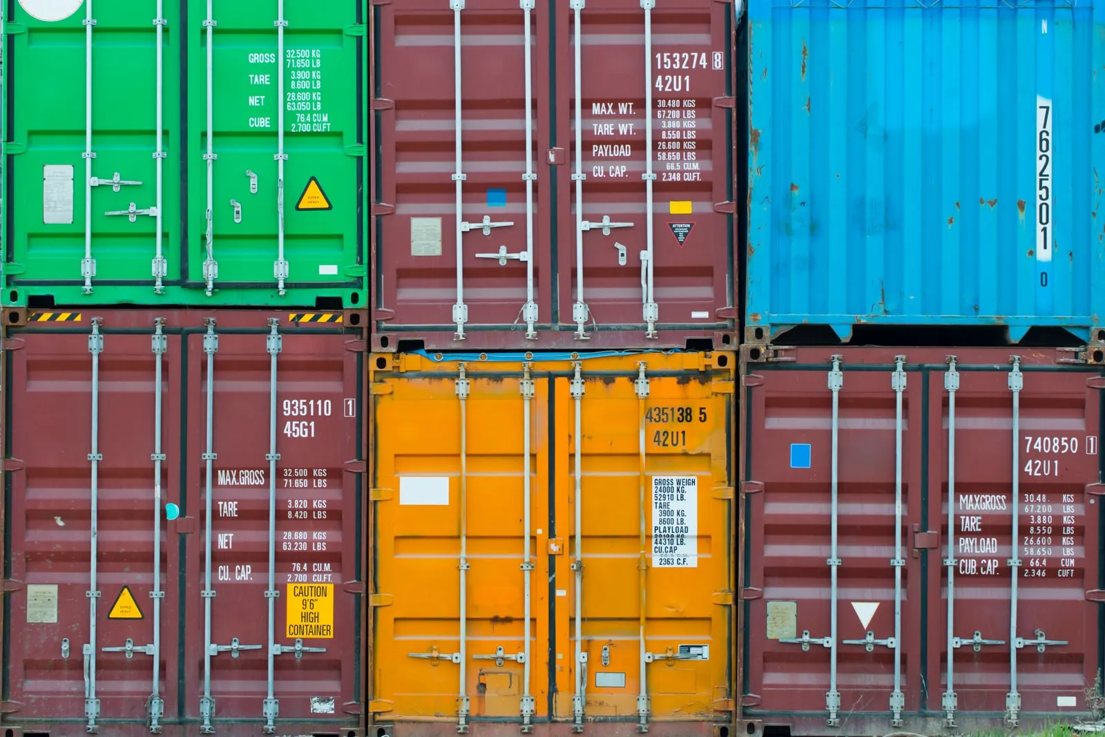 The closed doors of stacked shipping containers