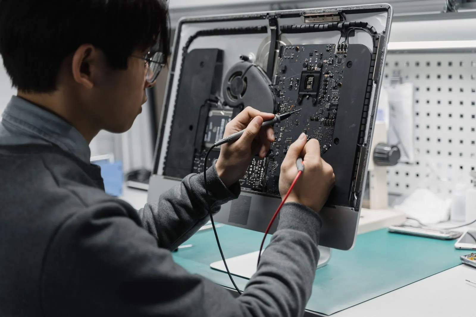 A technician working on computer hardware at a bench