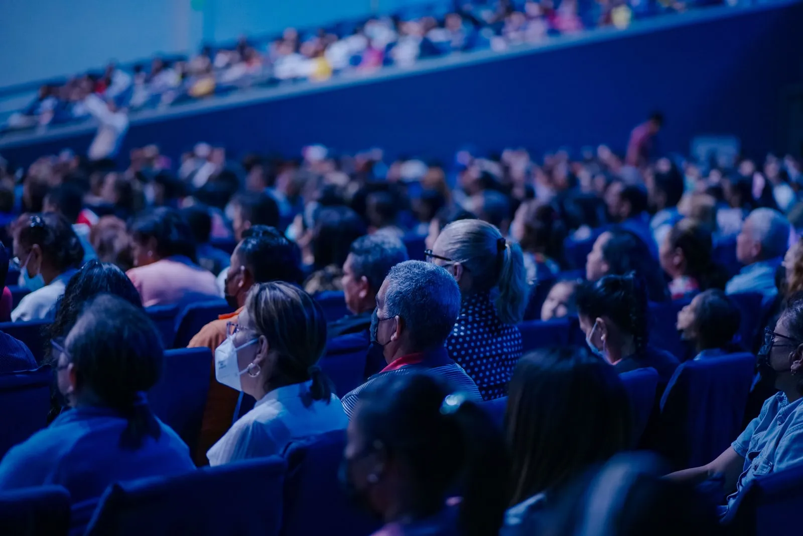 A conference auditorium with a seated audience