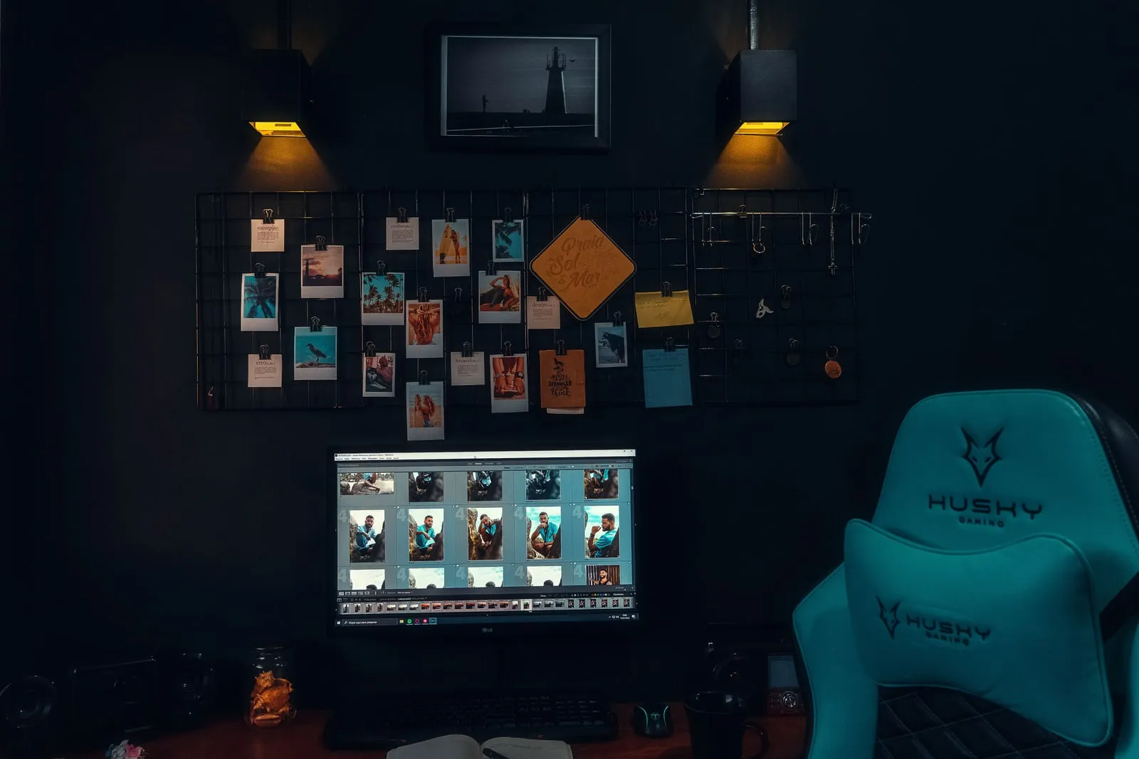 A laptop open on a desk in a dimly lit room