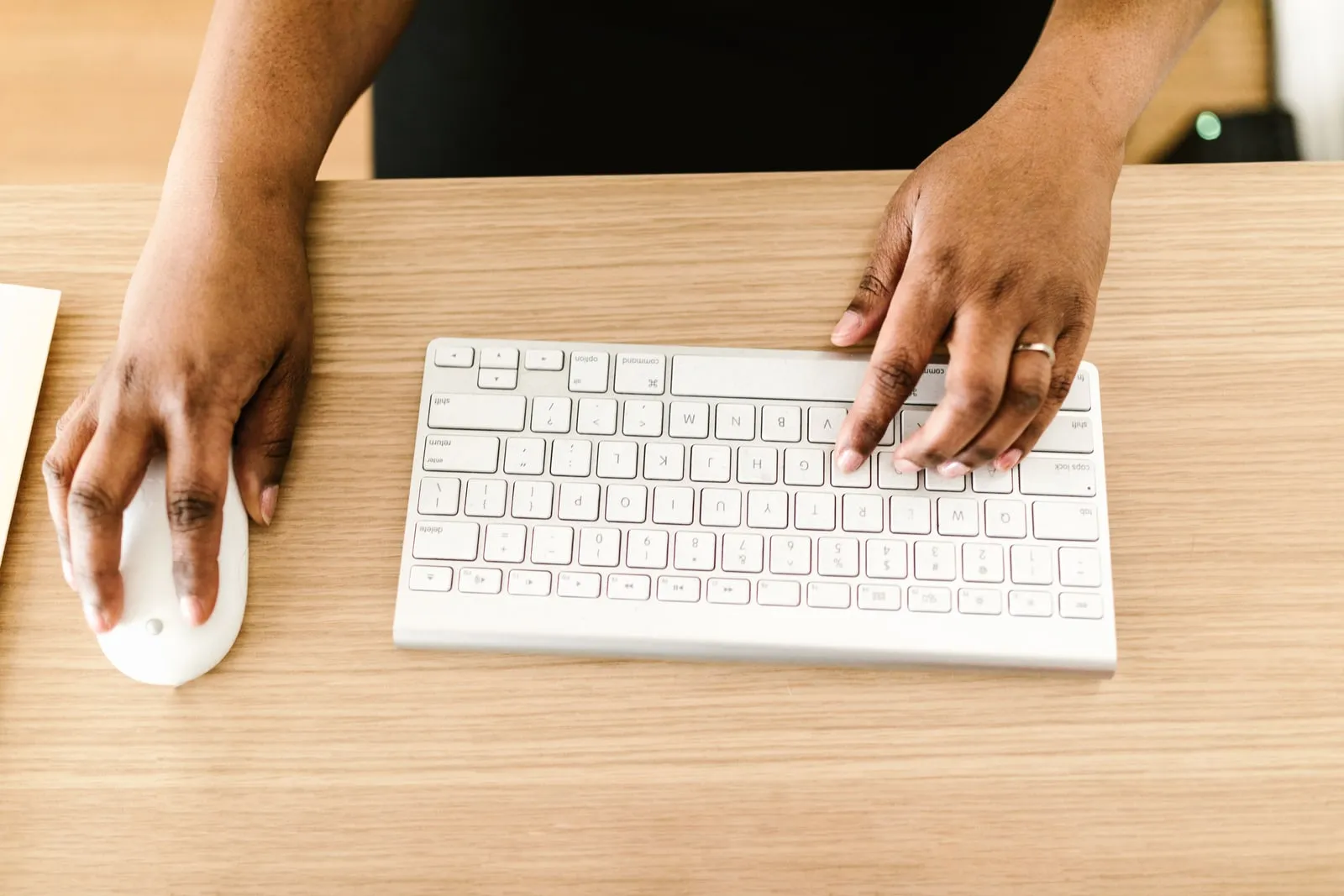 Hands on a mouse and a keyboard, seen from above