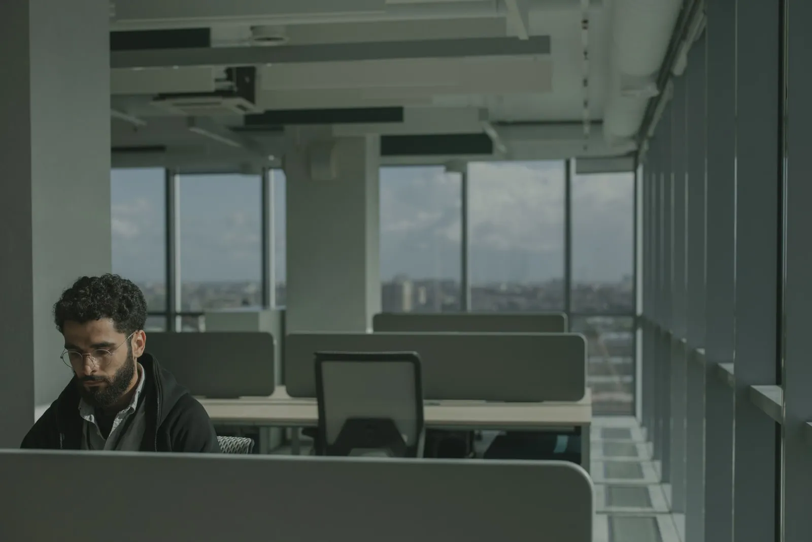 An office worker at a computer in an open plan office