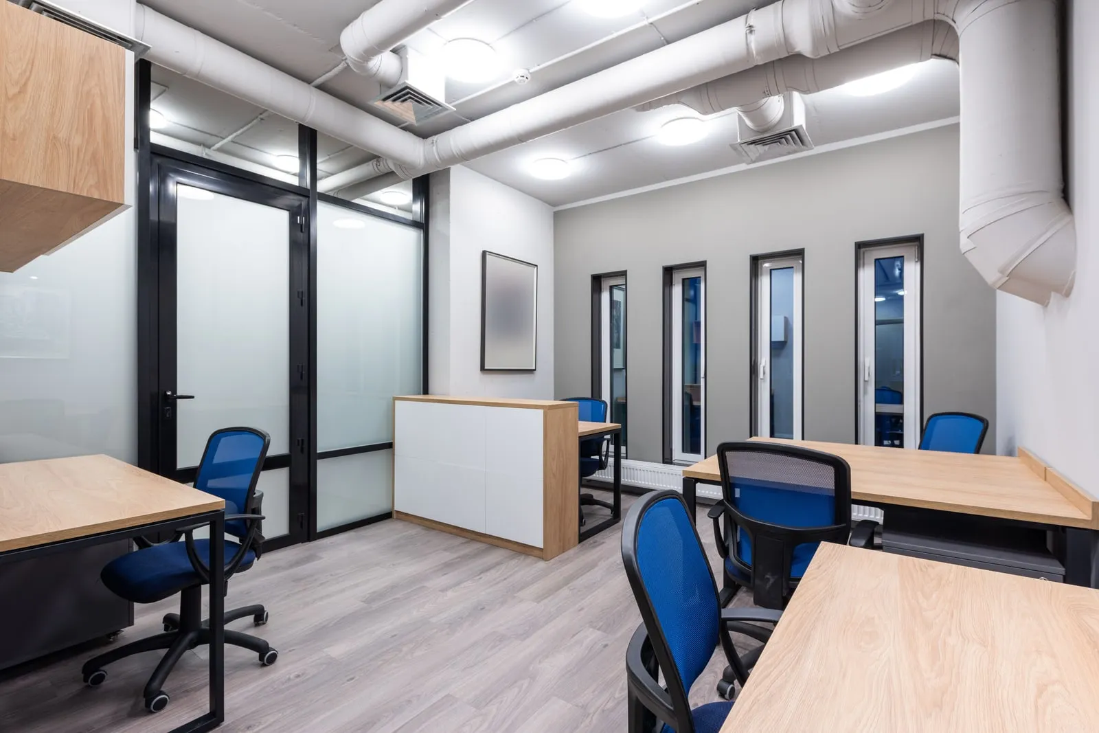 An empty modern startup office with rows of desks