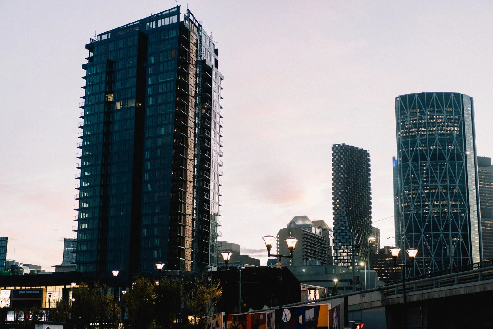 A city skyline of office towers at dusk