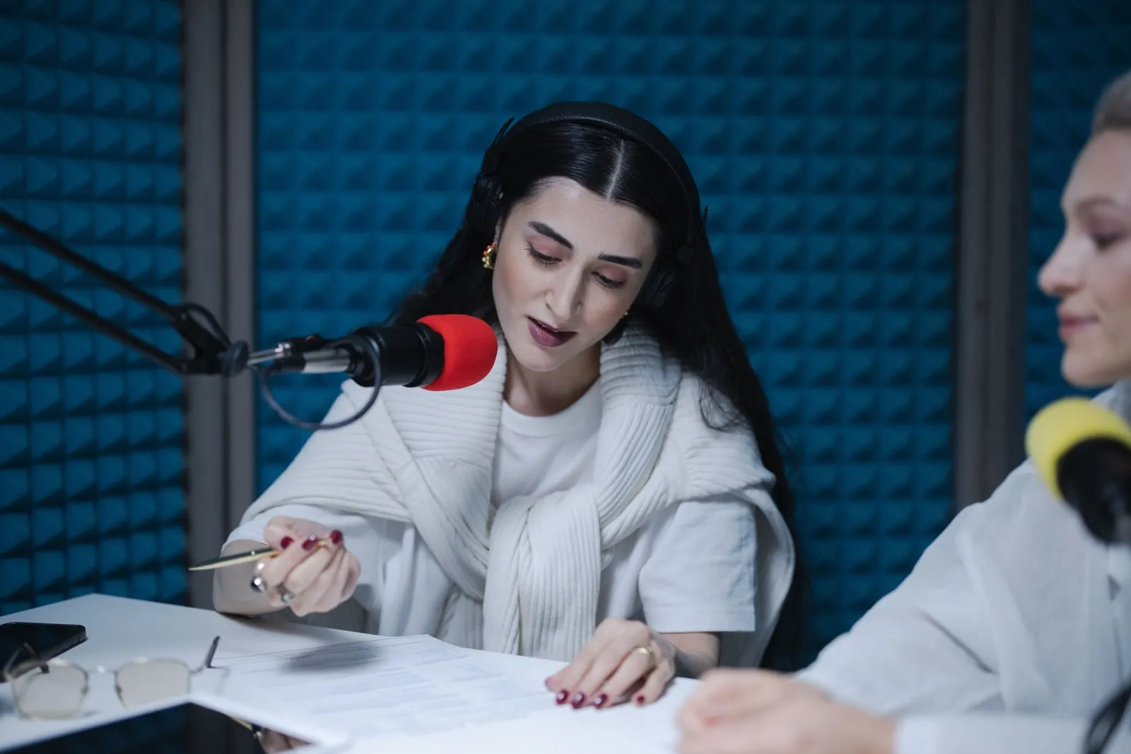 A person wearing headphones speaking into a microphone