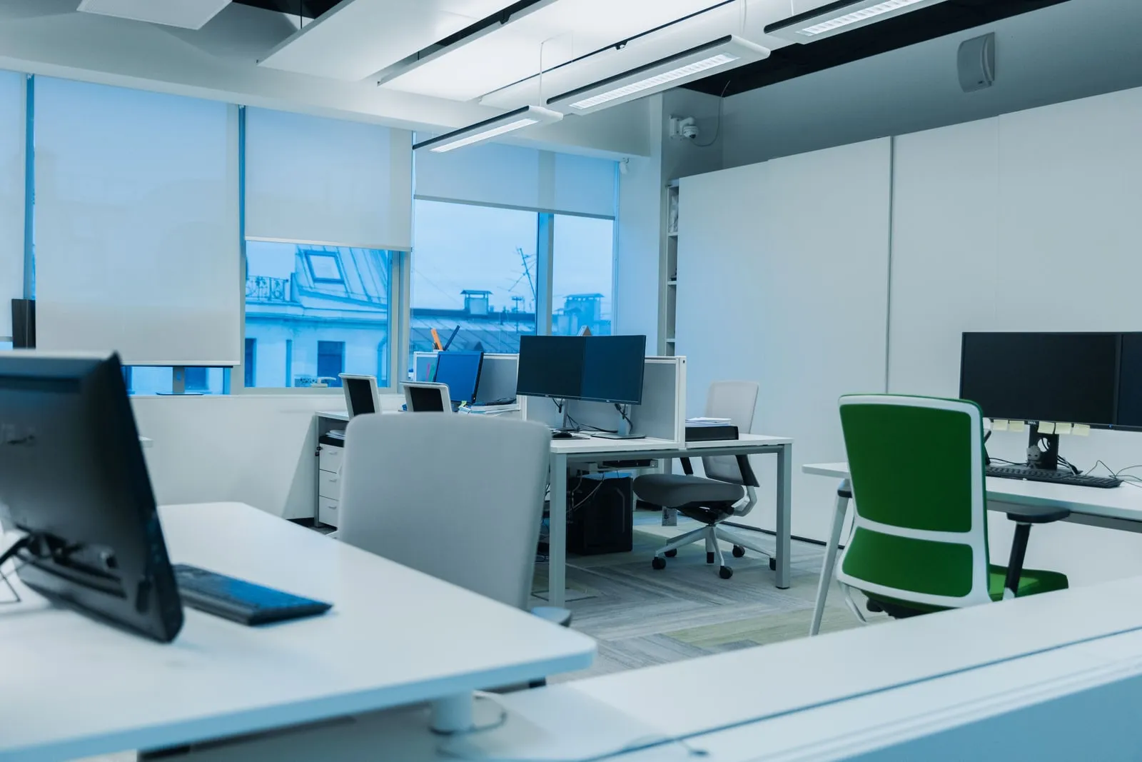 Rows of computer workstations in a large open-plan office