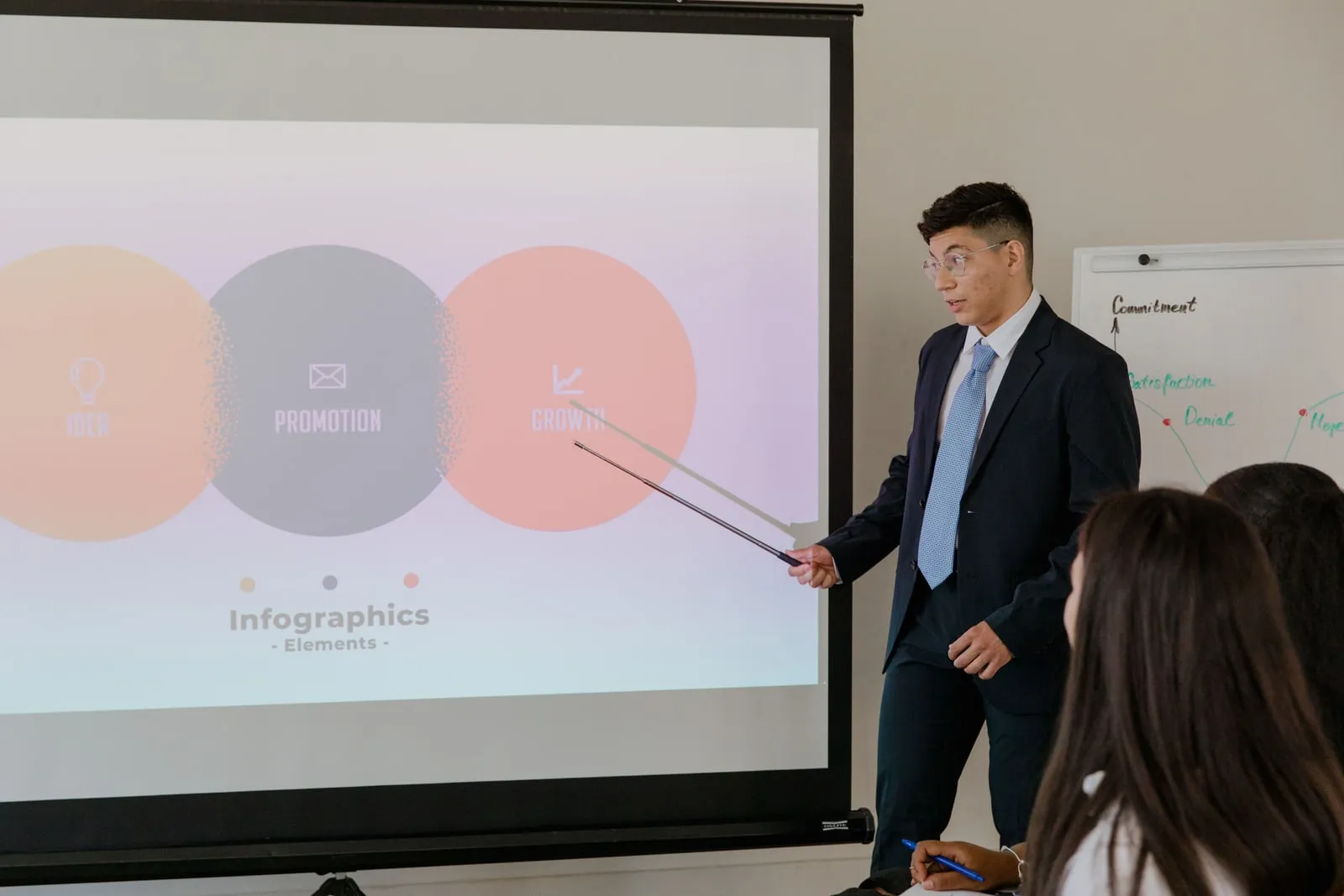 An economist presenting charts to an audience in a lecture hall