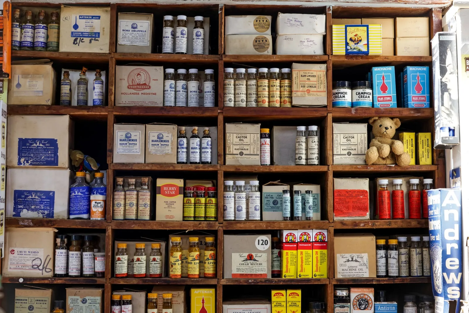 Shelves of medicine packaging in a pharmacy.