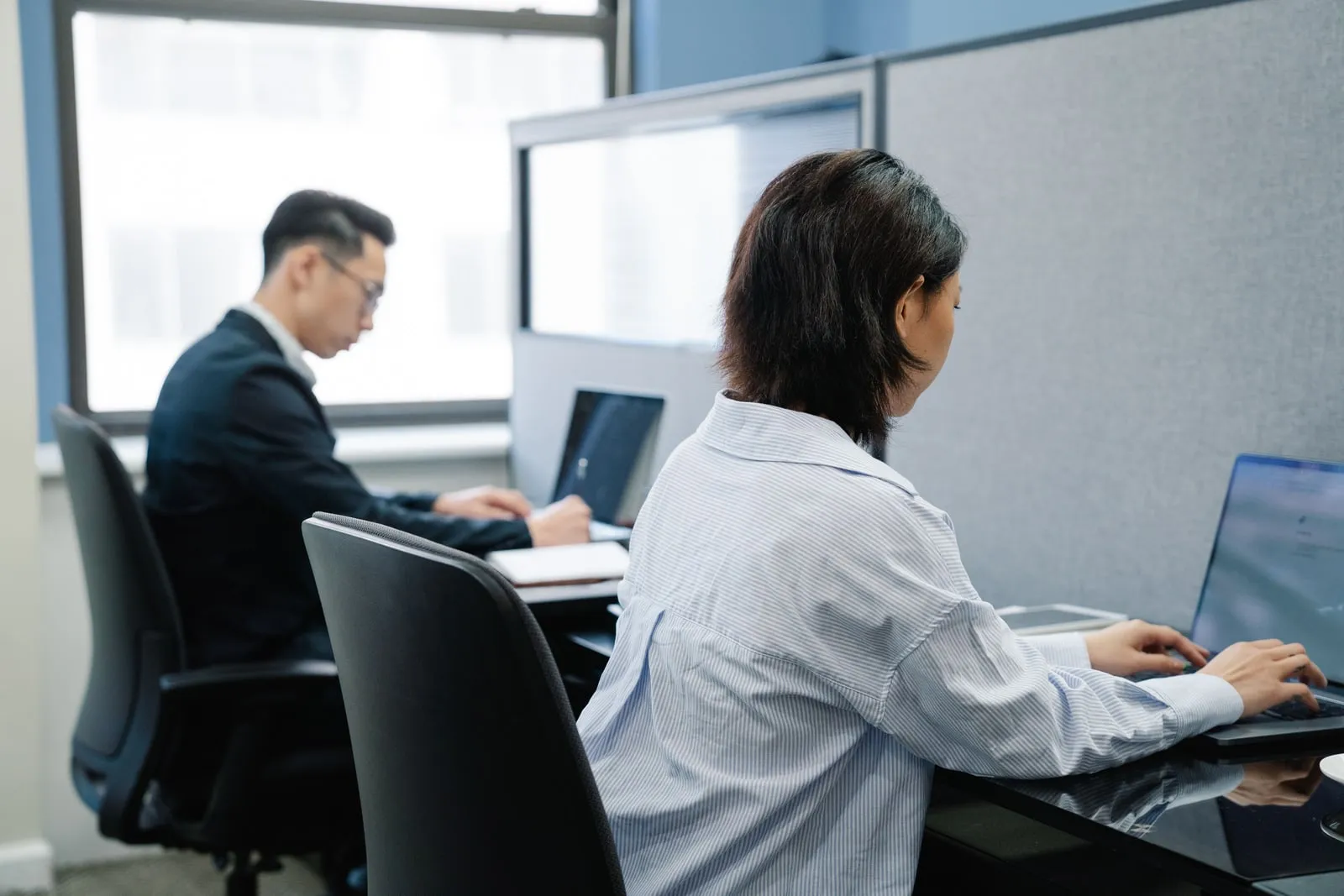 People working at desks in a small office