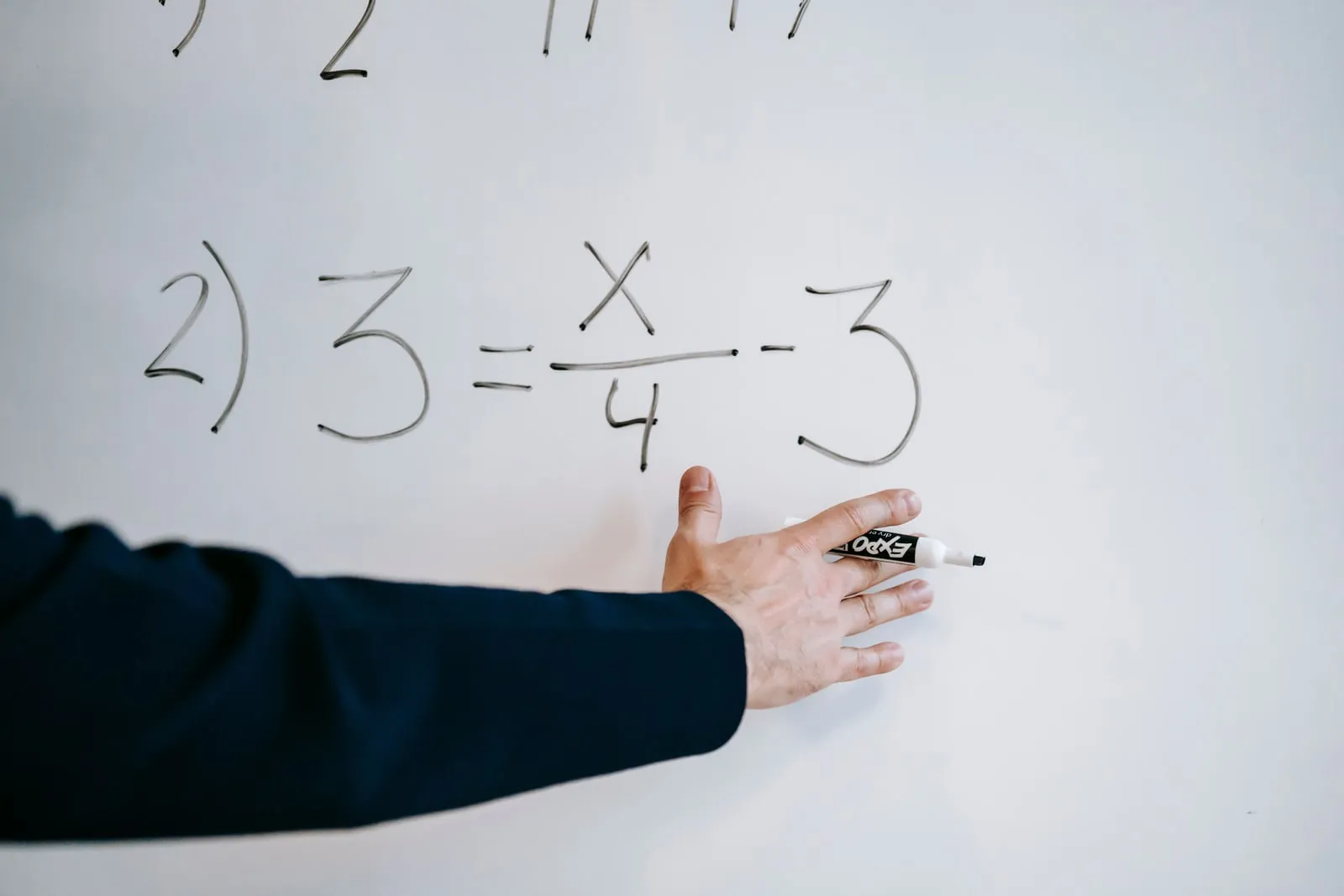 A researcher writing equations on a whiteboard