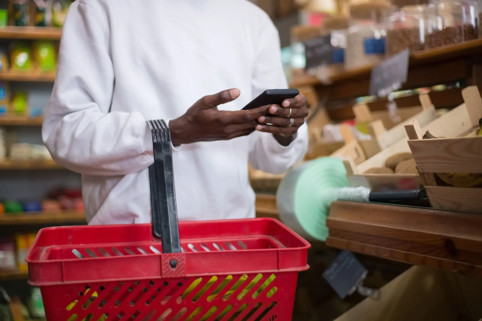 A person holding a phone while shopping in a store