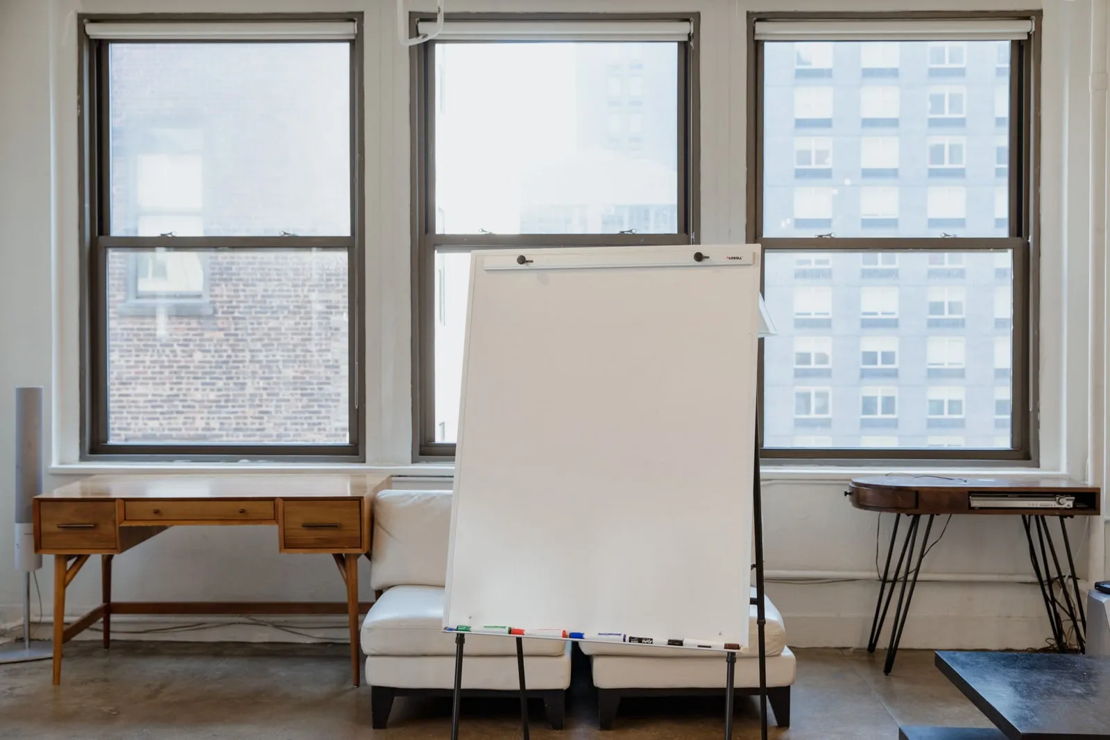 An empty meeting room with a whiteboard on the wall