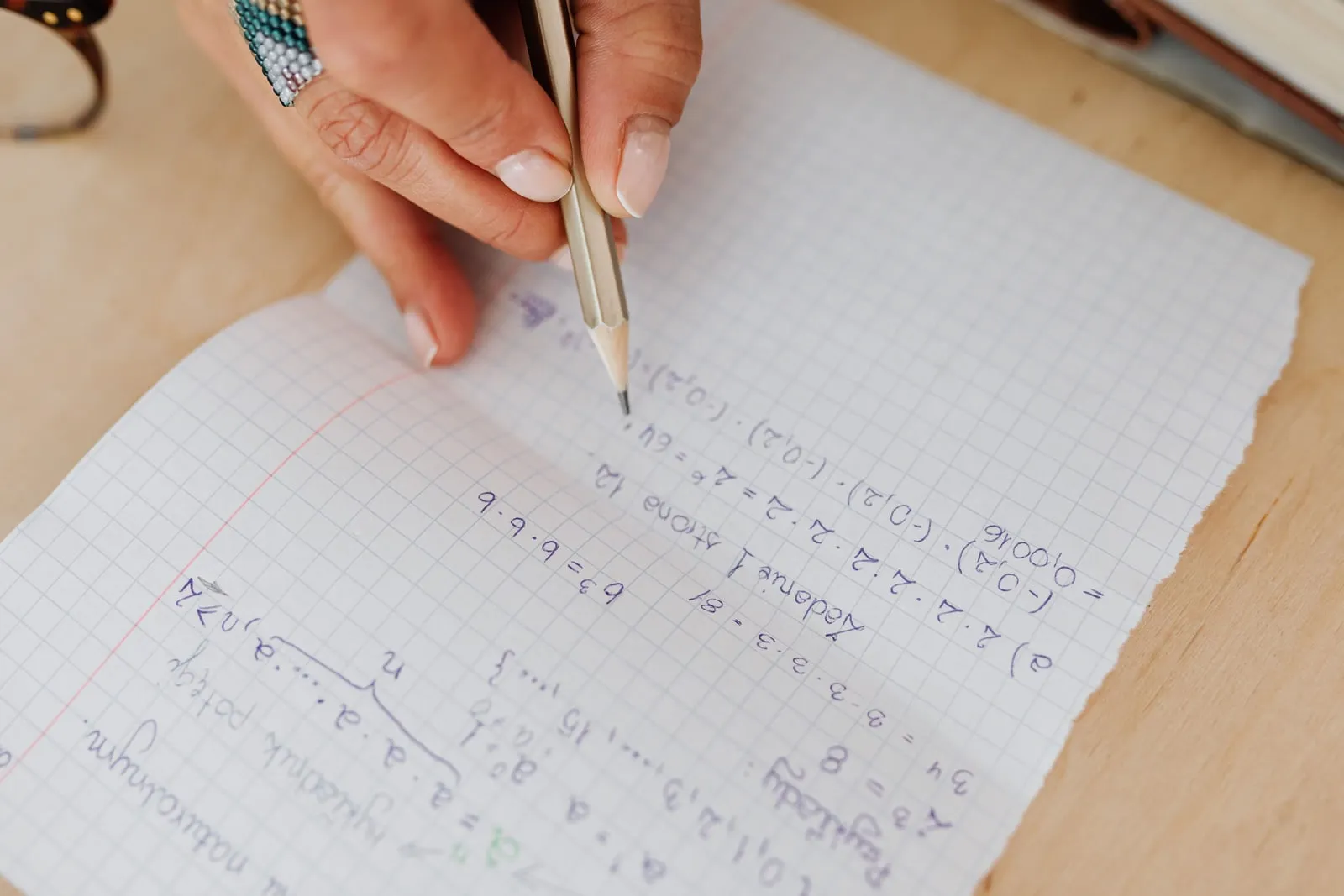An open notebook covered in handwritten equations