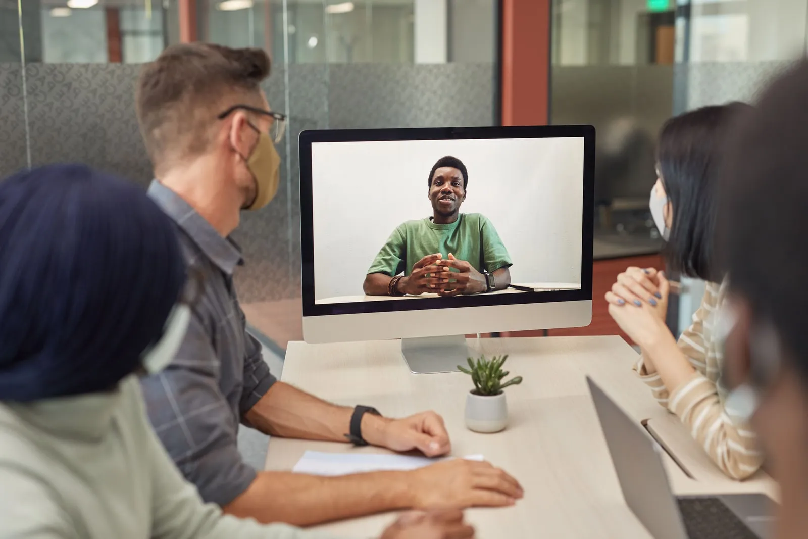 People in a conference room during a video call