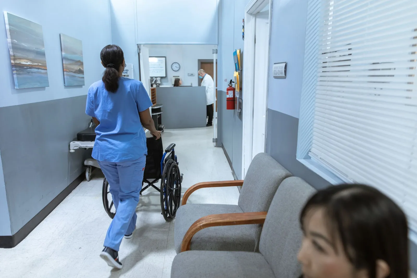 A nurse walking down a hospital corridor