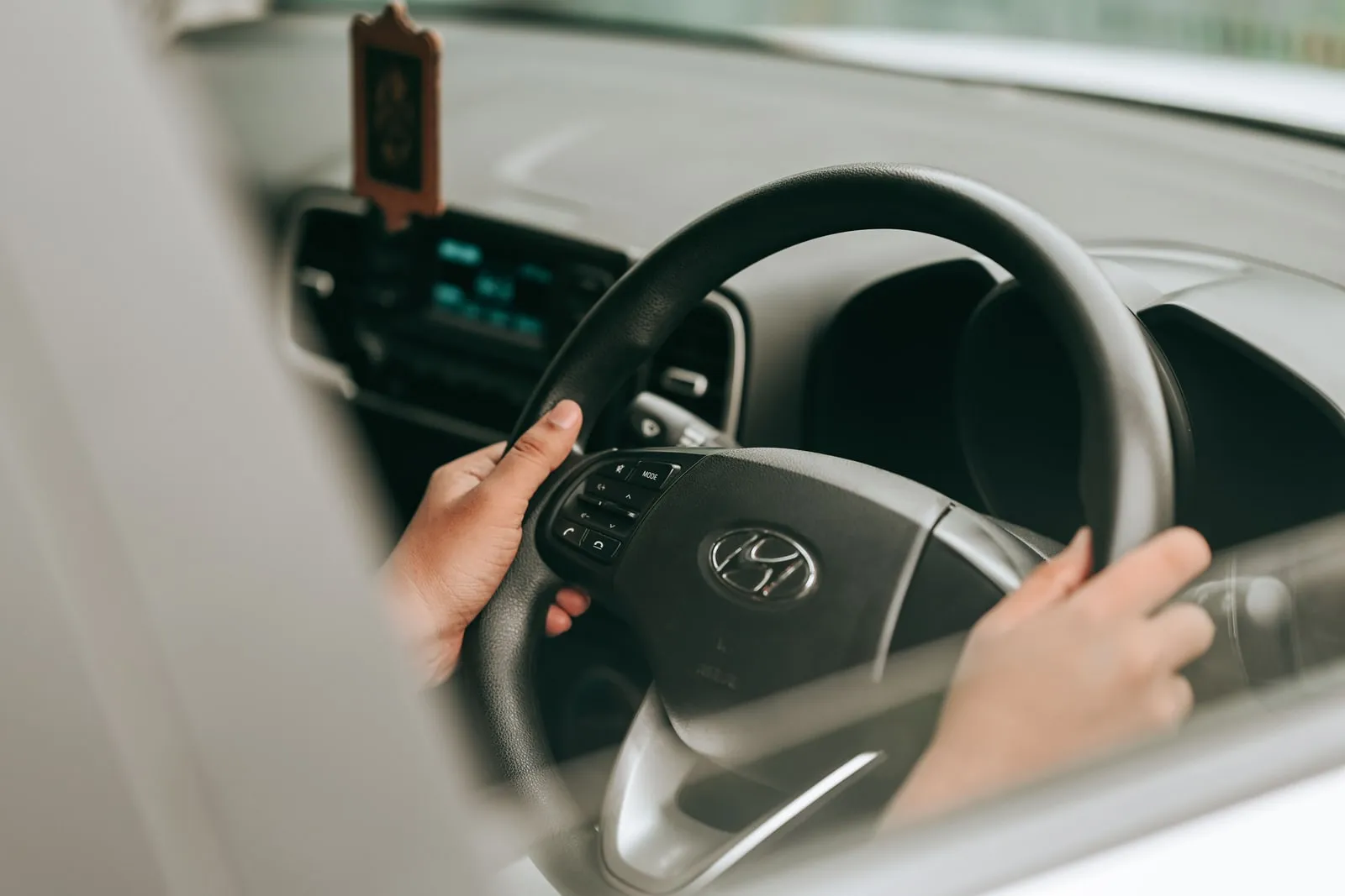 A car dashboard with a steering wheel